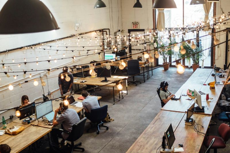 Clean, modern, 'hotelling' workstations in an open office environment