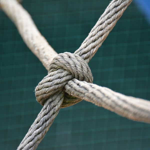 A rope joining into a central knot symbolizing a symmetrical geometric pattern of interconnected lines, symbolizing organizational harmony