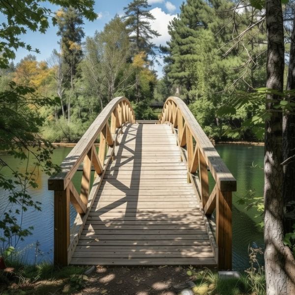 A solid wooden bridge rising in the centre over clear blue water representing the flow of ideas and successful communication.